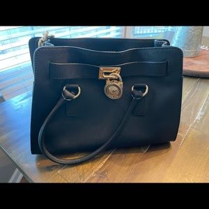 MK black pursue with gold accent